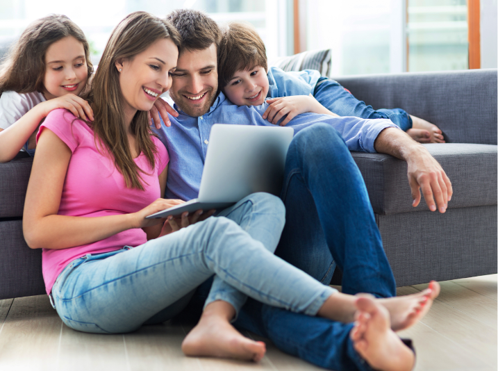 photograph of a family by a sofa mobile